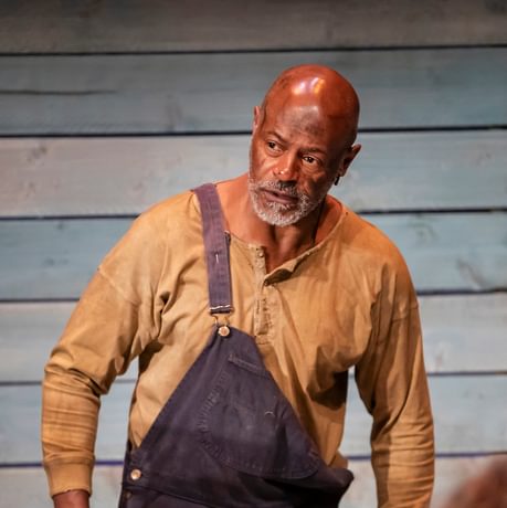 An actor is shown looking stern and serious