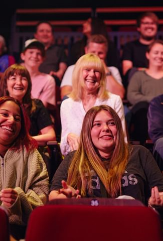 Image of audience sat enjoying a show