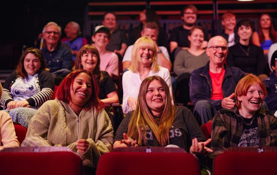 Image of audience sat enjoying a show