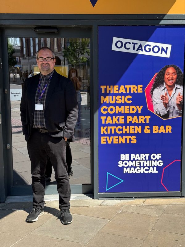Gareth Redston stood in-front of the entrance to the Octagon Theatre.