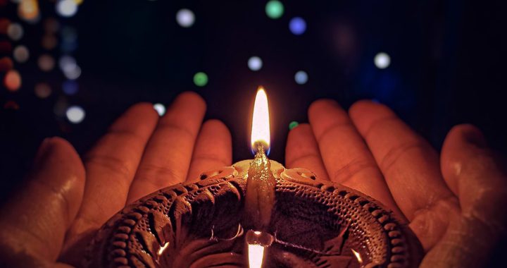 Diwali image - person holding candle in their hands