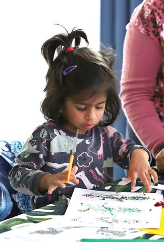 Small child doing Diwali craft