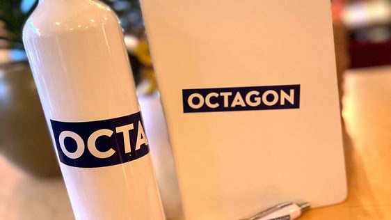White notebook with Octagon purple logo