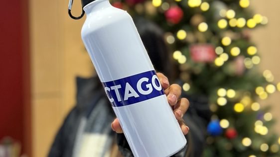 White metal water bottle with purple Octagon logo