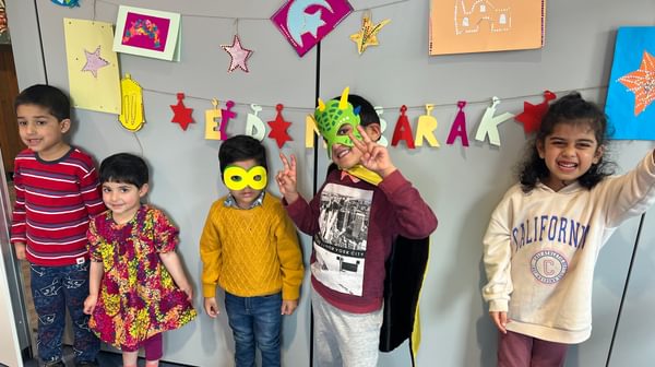 Image of children with Eid decorations behind them