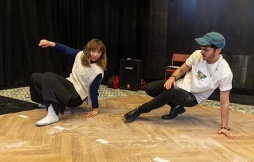 Two actors are shown crouched on the floor, doing Northern Soul dance moves