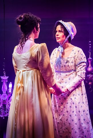 two women in regency clothing holding hands and looking intensely at each other