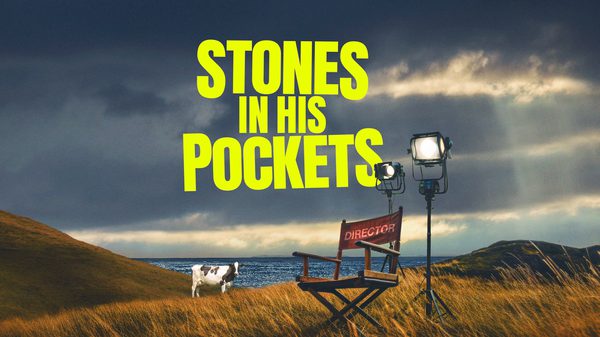 Stones in his pockets title with a director chair in a field and a cow in the background