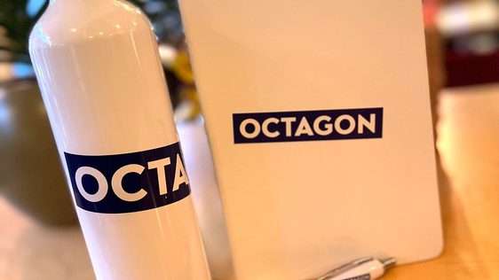White notebook with Octagon purple logo