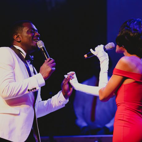 A group of singers in 1960s outfits