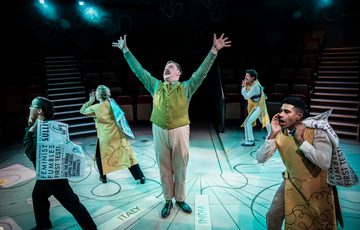 Actor in the centre of the stage with arms outstretched