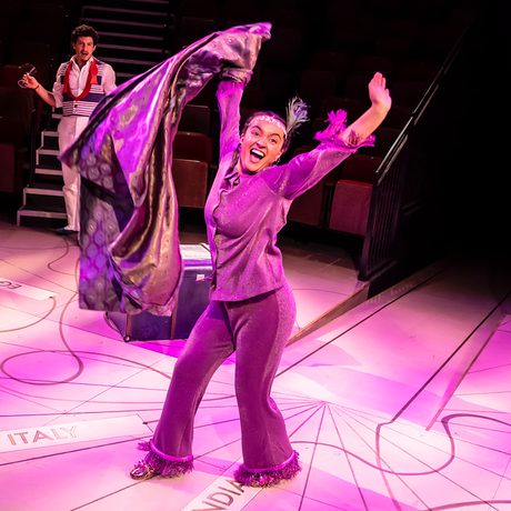 Actor in 1920s outfit dancing in the centre of the stage