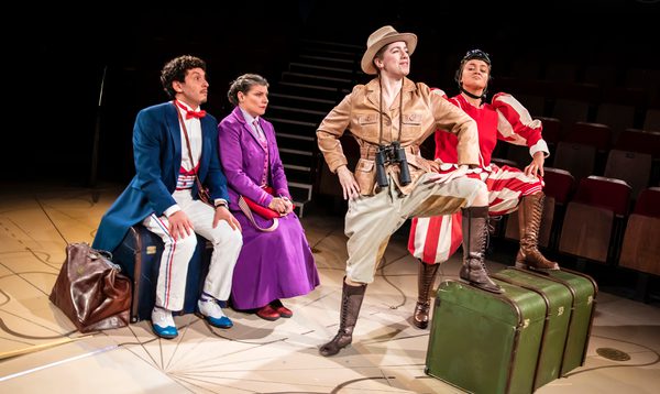 4 people take centre stage. 2 at the back sit on a chest, the 2 at the front stand gallantly with one foot on the chest, the other on the ground.