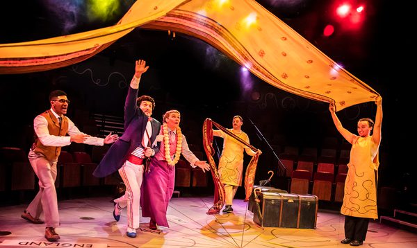 2 characters running underneath a bright coloured piece of material