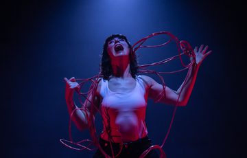 Woman in distress with wires around her