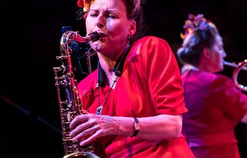 Blonde woman playing saxophone