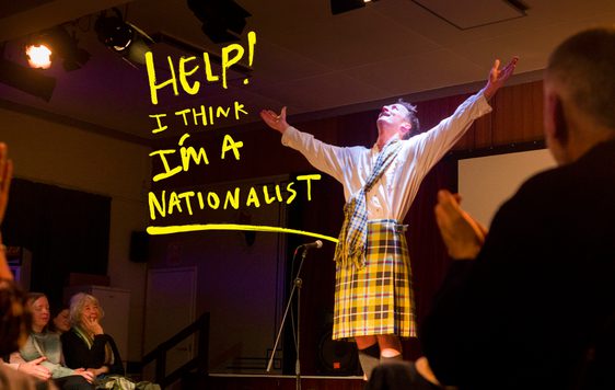 man in kilt with arms aloft.