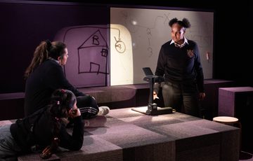 Three women on stage talking