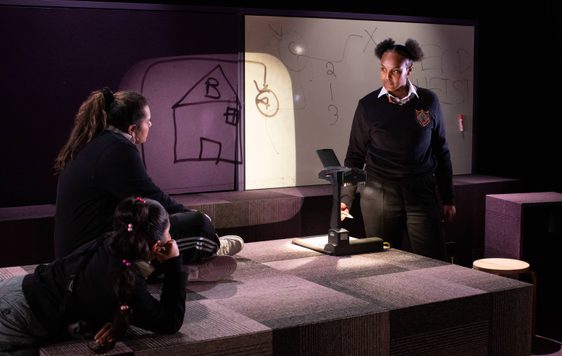 Three women on stage talking