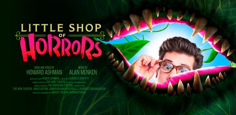 Image of a man peaking through a plant mouth