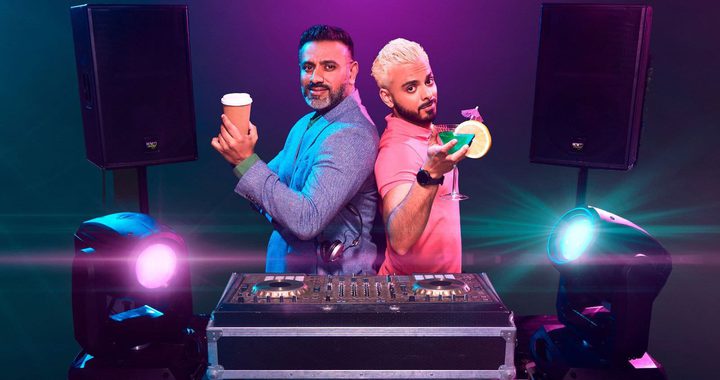 2 Asian men stood behind a DJ set. The older man has a coffee and the younger man has a cocktail.