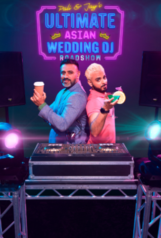 2 Asian men stood behind a DJ set. The older man has a coffee and the younger man has a cocktail.