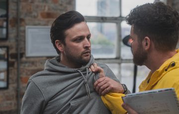 A man is tugging another man