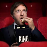 Image of Andrew Maxwell eating popcorn