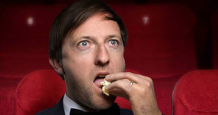 Image of Andrew Maxwell eating popcorn