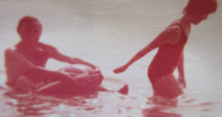 Old photo of a father and daughter in the sea