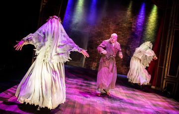 Image a scary looking bride with a veil and man in a dressing gown looking scared