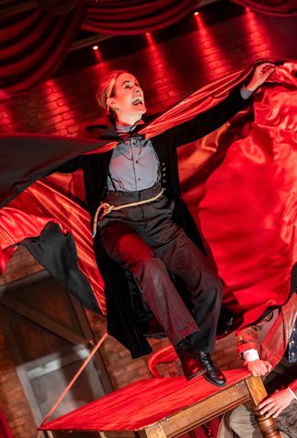 Dracula leaping with a cloak with red lining