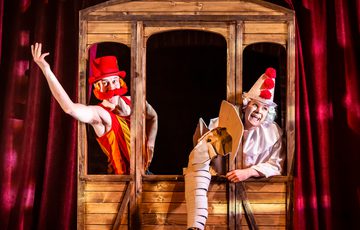 Man and woman in circus outfits