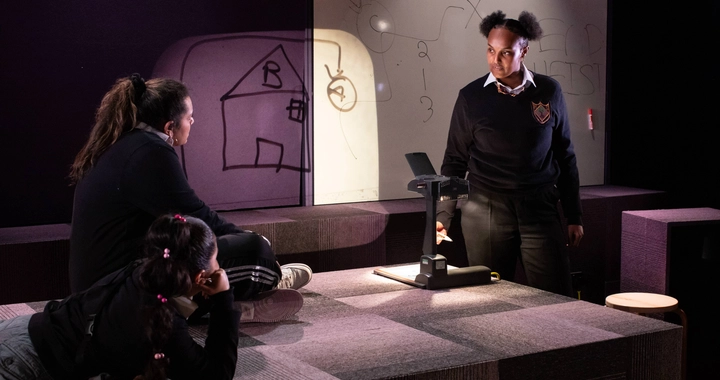 Three women on stage talking