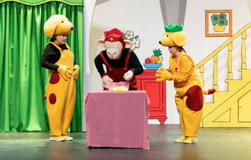 Spot the Dog with his friends looking at the cake on the table