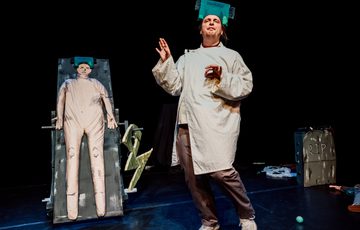 An actor is shown dressed as a scientist.