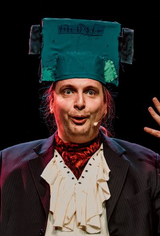 Image shows actor with a Frankenstein inspired head piece on