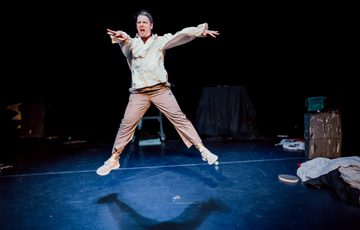 Actor is shown in mid air as they jump.