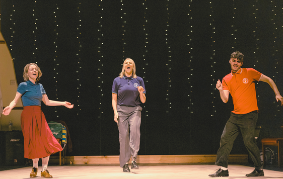Actors on stage dancing