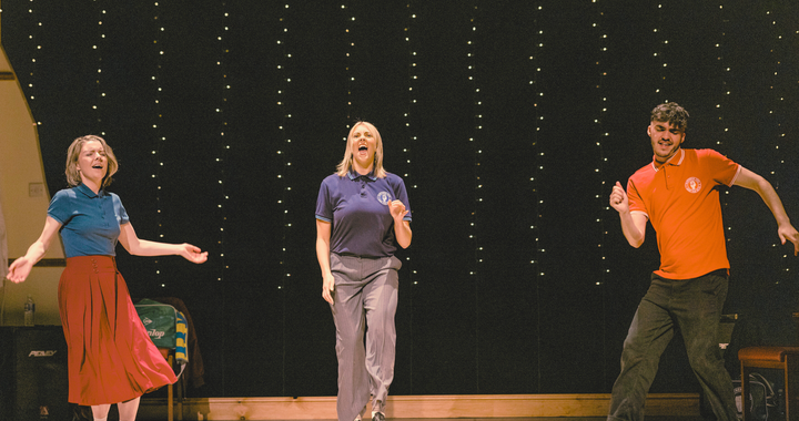 Actors on stage dancing