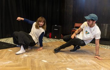 Two actors are shown crouched on the floor, doing Northern Soul dance moves