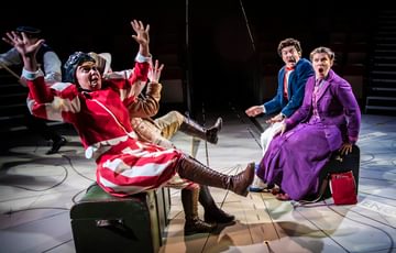 Actors with hands up in the air and looking shocked