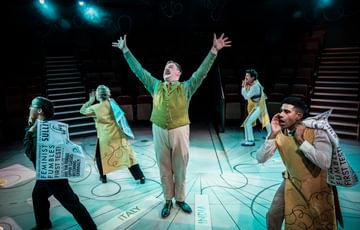 Actor in the centre of the stage with arms outstretched