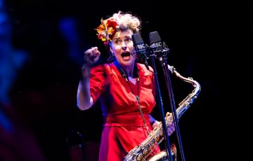 Blonde woman holding saxophone