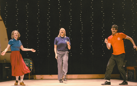 Actors on stage dancing