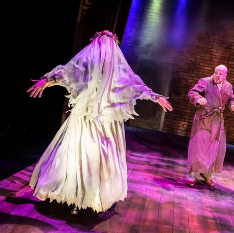 Image a scary looking bride with a veil and man in a dressing gown looking scared