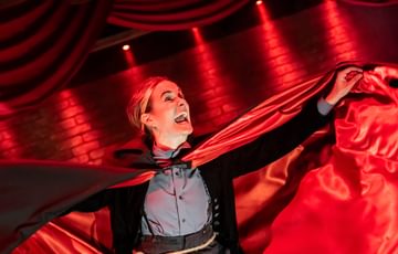 Dracula leaping with a cloak with red lining