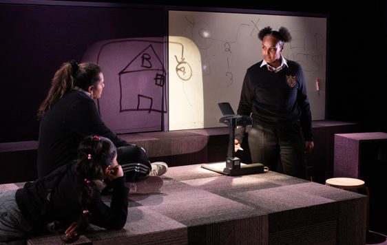 Three women on stage talking