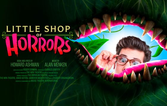 Image of a man peaking through a plant mouth