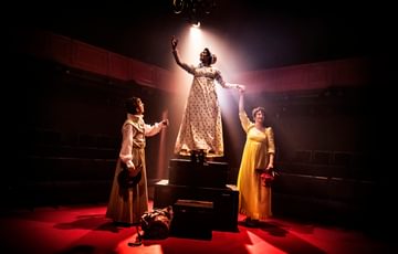 3 people on stage in regency clothing